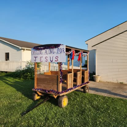 'Chugging Along for Jesus' decorated parade wagon outside the church